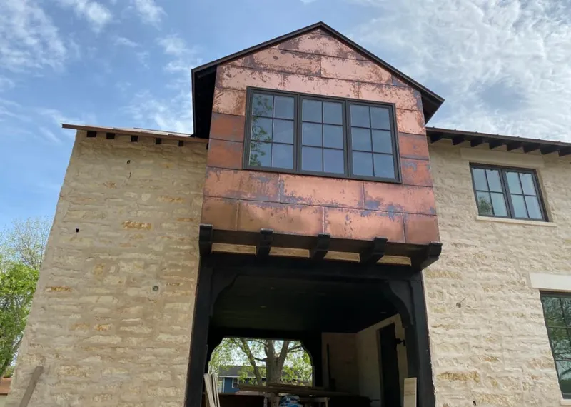 Copper metal panel facade on a stone building for Skylight Installation in Lufkin