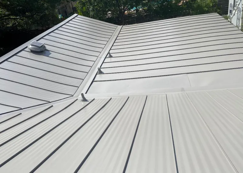 Solar attic fan installed on a metal roof for Roof Ventilation in Lufkin